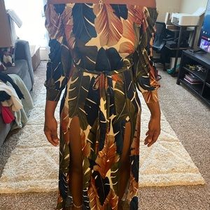 Green one piece romper with leaf accents (shorts attached)